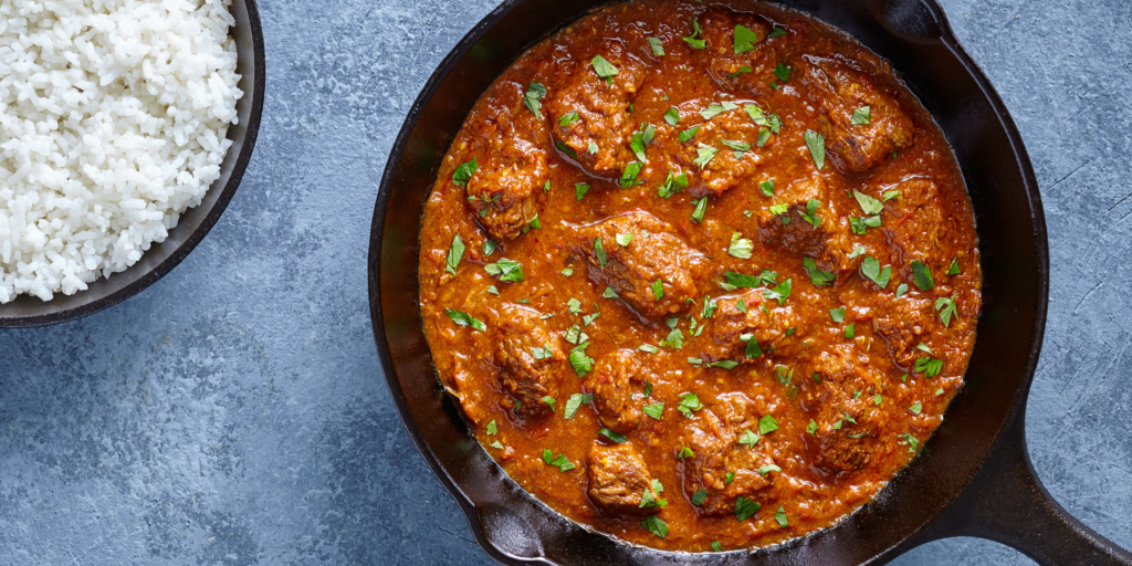 Seekh Kebabs diced in a tomato based curry 