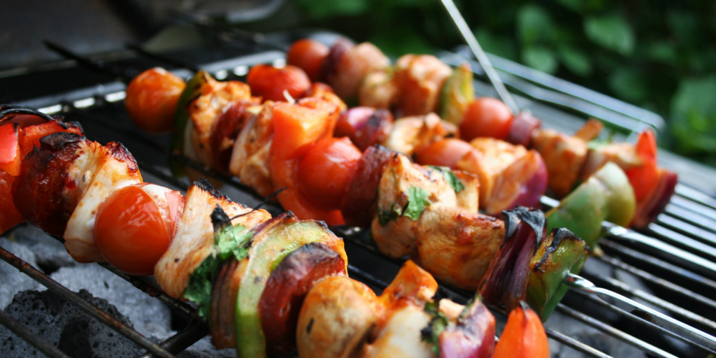 Kebabs cut into pieces and grilled with veggies on a skewer 