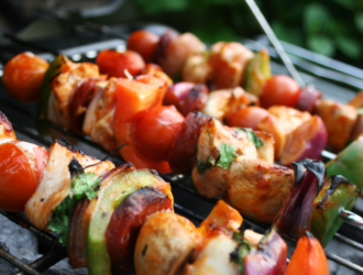 Kebabs cut into pieces and grilled with veggies on a skewer