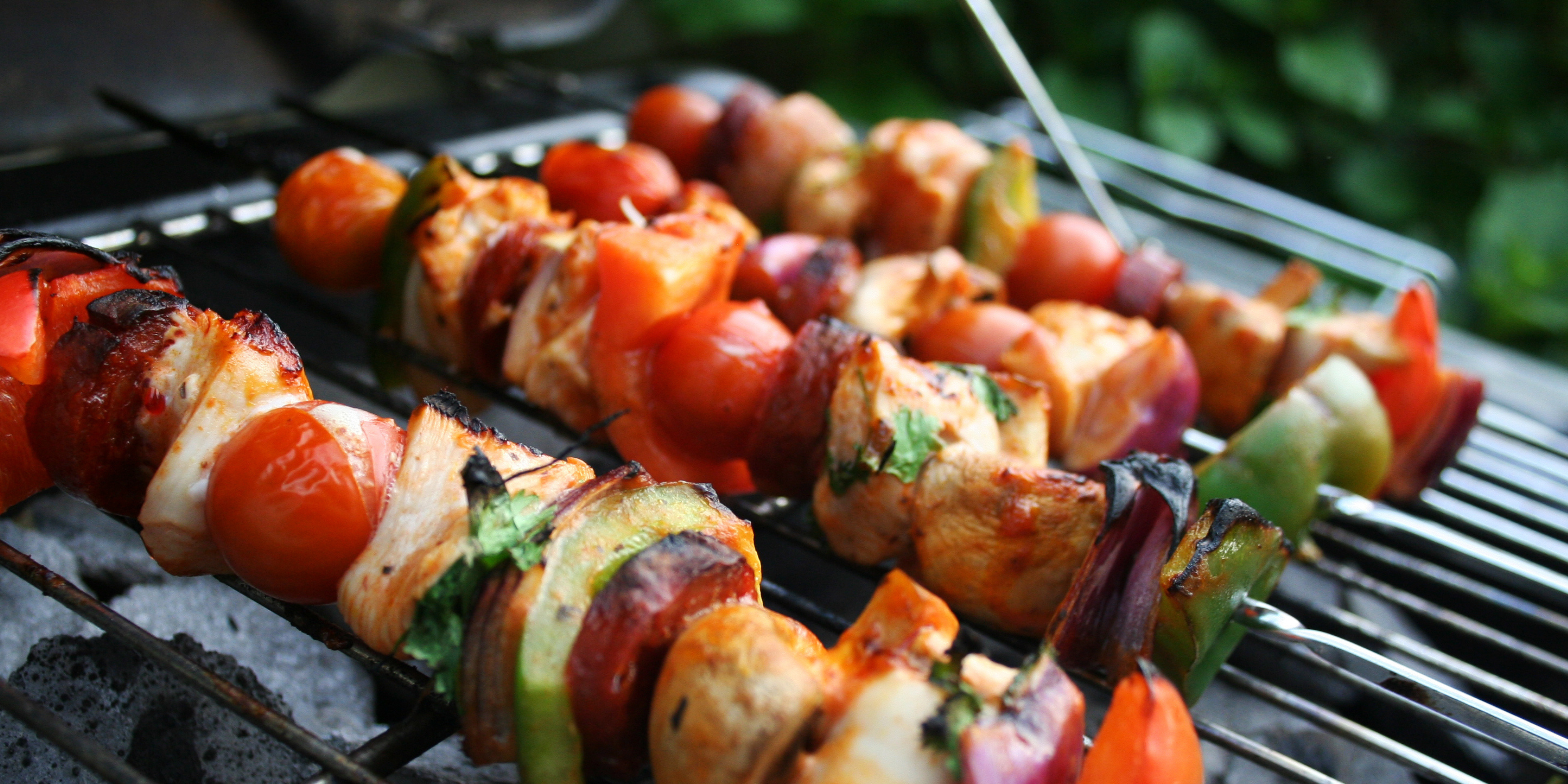 Kebabs cut into pieces and grilled with veggies on a skewer