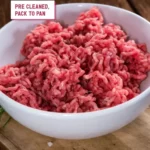 Fresh premium mutton mince in a white bowl on a wooden board